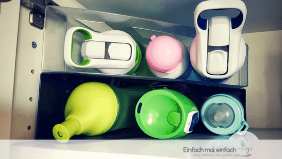 Several water bottles arranged in magazine folders.