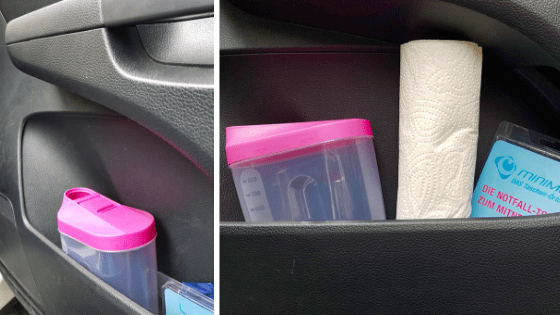 a plastic container and paper towel in a car