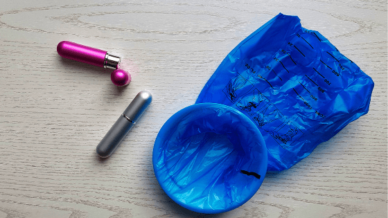 a blue plastic bag with a pink object next to a pink object