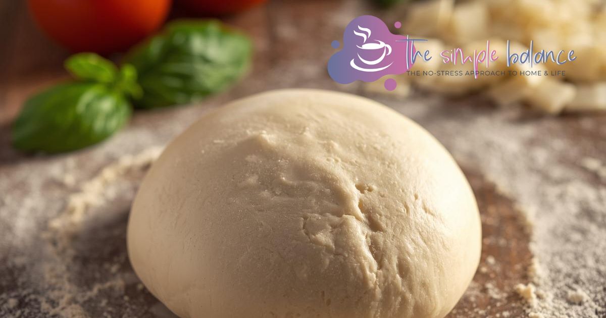 Fresh pizza dough on a countertop.